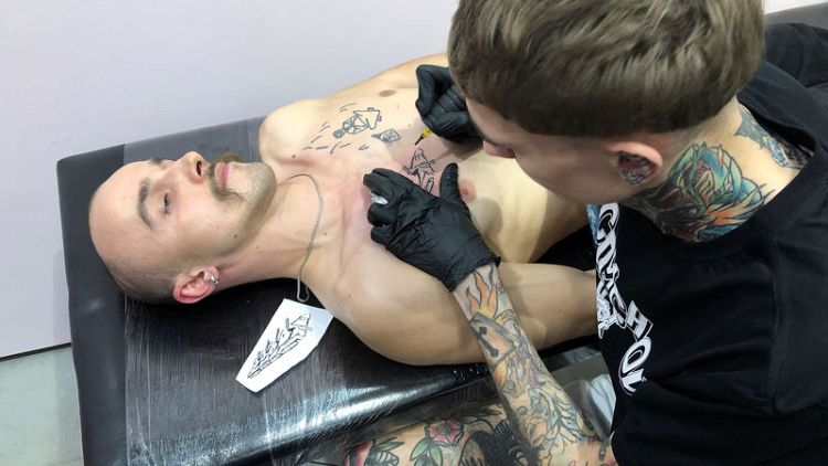 Barbed wire and black humour: Russian activists line up for protest tattoos