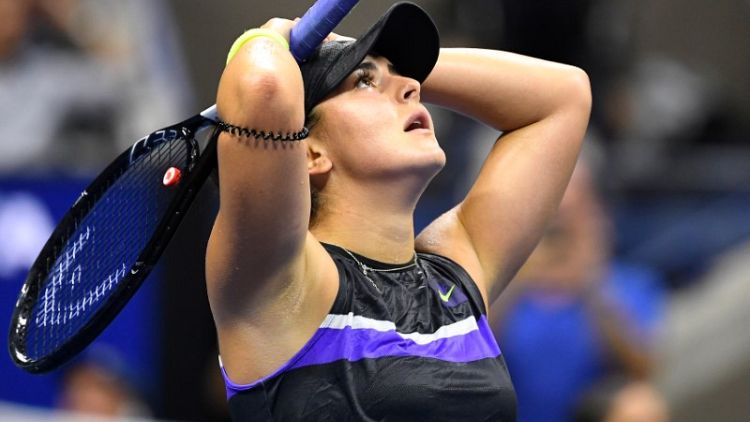 Andreescu battles back to see off Mertens in New York