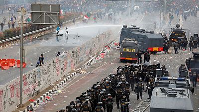 Police fire water cannon as Indonesians rally against new laws