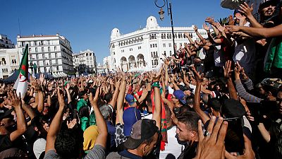 Algerians tired of ruling cadre march as ex-premiers bid for presidency