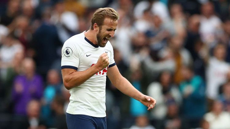 Ten-man Tottenham escape to victory as Kane strikes
