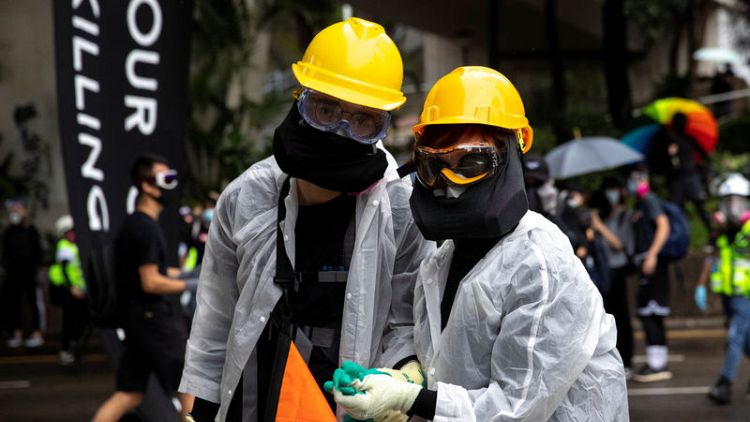 Police say 77 people arrested in Hong Kong for anti-mask law violations