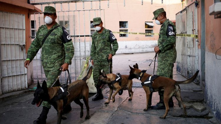 Police, dogs search notorious Mexican prison for clandestine graves
