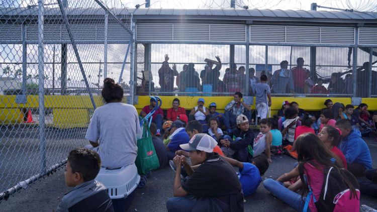 Migrant protesters occupy U.S.-Mexico border bridge, close crossing