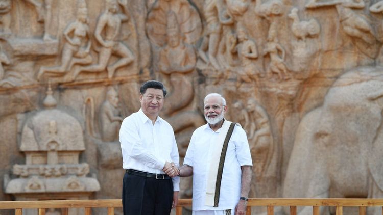 India's Modi picks up trash from seaside town while hosting China's Xi