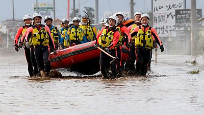 Japan rescuers wade in muddy waters to find typhoon survivors Japan rescuers wade in muddy waters to find typhoon survivors