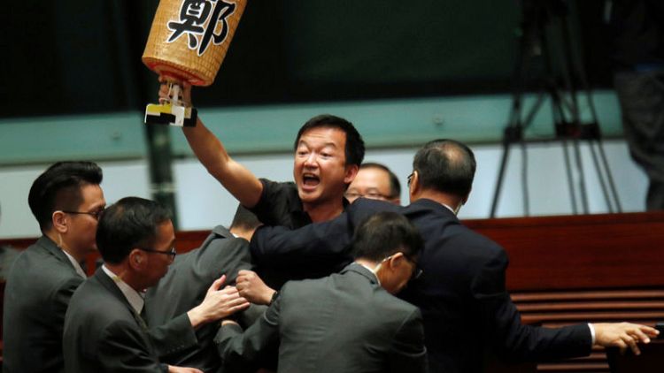Hong Kong legislative session adjourned amid protests and heckling