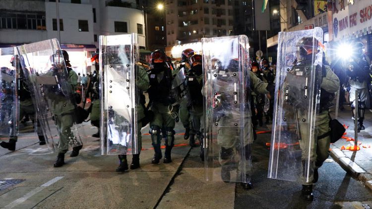 Hong Kong riot police teargas, chase protesters, residents jeer officers