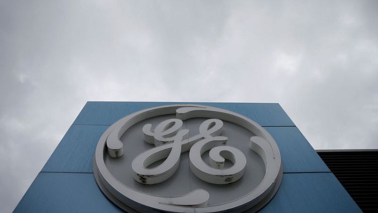 GE posts another loss, raises cash flow forecast