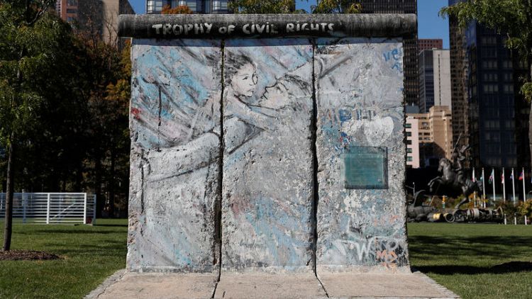 Thirty years after it fell, Berlin Wall lives on in parks, squares and souvenirs
