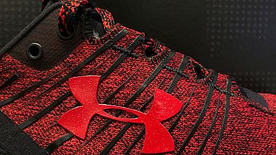 Under Armour cuts revenue forecast; federal probe weighs on shares
