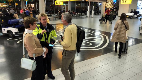 Pilot accidentally hits hostage alarm, causing lockdown at Amsterdam's Schiphol airport Pilot accidentally hits hostage alarm, causing lockdown at Amsterdam's Schiphol airport