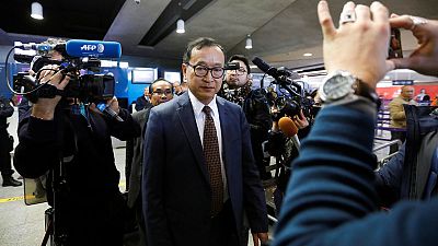 Cambodian opposition figure Sam Rainsy boards plane in Paris