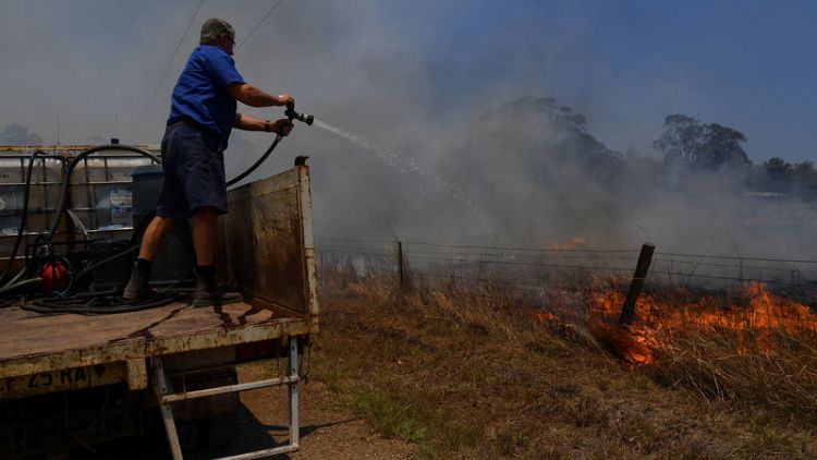 Australians shelter and flee as firefighters battle 150 bushfires