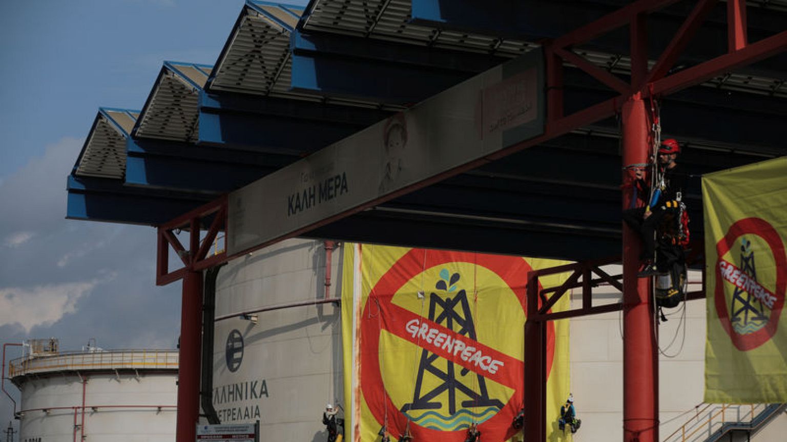 Greenpeace activists abseil down Hellenic Petroleum storage tank to protest 'climate emergency'