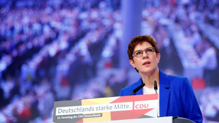 Back me or sack me, protege of Germany's Merkel tells her party