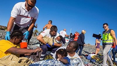 Sunbathers join rescue as migrant boat washes up on Canary Islands beach