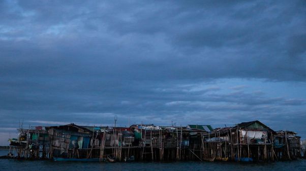 Rising seas threaten early end for sinking village in Philippines Rising seas threaten early end for sinking village in Philippines