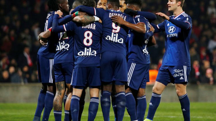 Lyon thrash nine-man Nimes to go fifth in Ligue 1