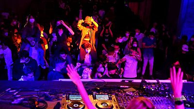 Euphoric clubbers hit dance floor again as Spain trials digital COVID-19 pass