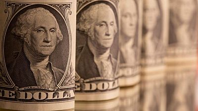 Dollar higher on upbeat U.S. data but set for weekly losses