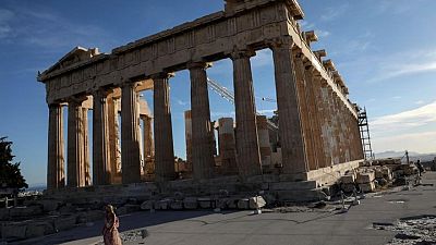 Greece banks on tourists for bad loan relief