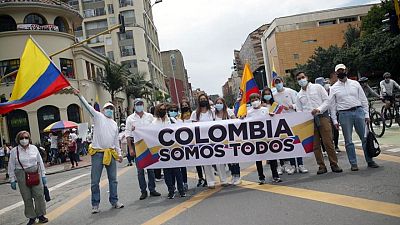 Colombia to probe police who stood by as civilians shot at protesters Colombia to probe police who stood by as civilians shot at protesters