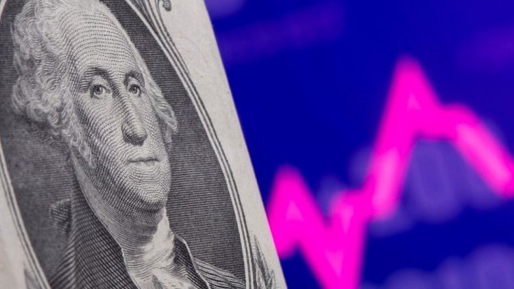 Dollar hovers near one-month high with market frozen before Fed test