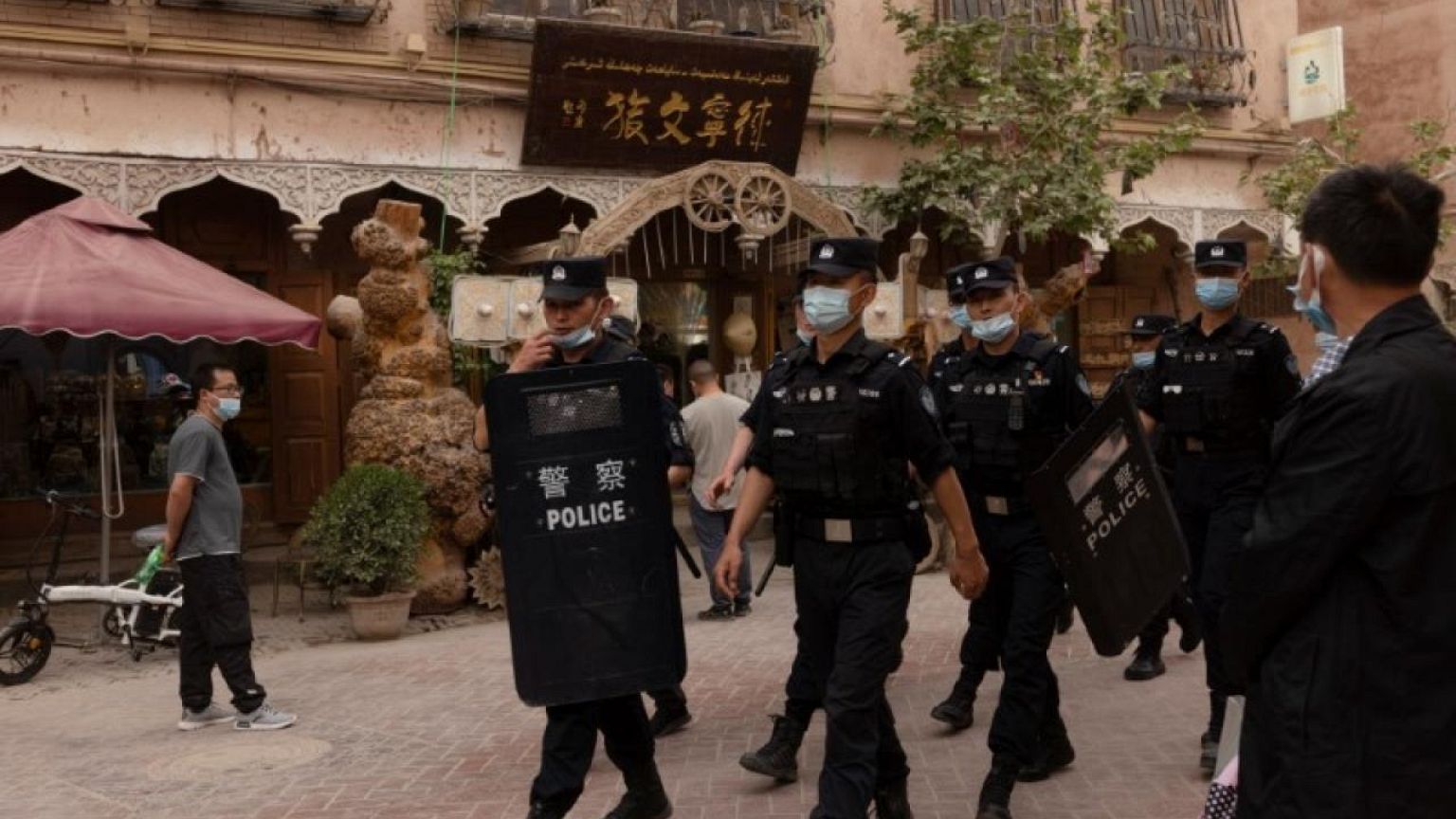 In China's new Xinjiang: patriotic tourism, riot police and minders