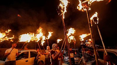 Lasers and flaming torches light up battle over new Israeli settlement Lasers and flaming torches light up battle over new Israeli settlement