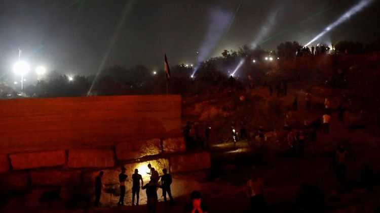 أضواء ليزر وشعلات نار تضيء سماء معركة ضد مستوطنة يهودية جديدة بالضفة الغربية