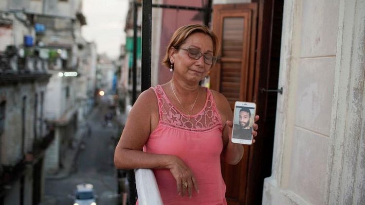 As Cuba begins handing out sentences to protesters, some families left in the dark