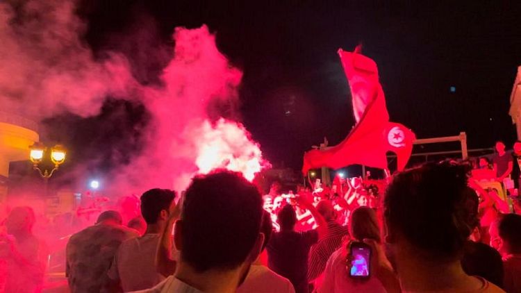 Supporters of Tunisian president celebrate government ousting with cheers, fireworks