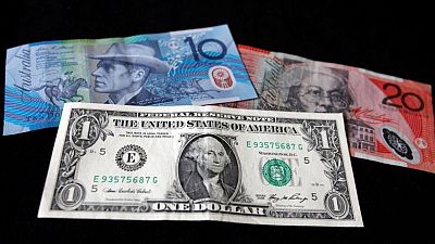 Dollar hovers near lows as kiwi climbs