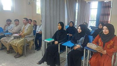 A curtain divides male, female students as Afghan universities reopen A curtain divides male, female students as Afghan universities reopen