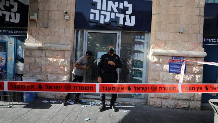 Palestinian stabs two in Jerusalem shop before being shot, Israeli police say