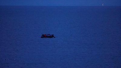 A migrant dinghy evades the grasp of French police A migrant dinghy evades the grasp of French police