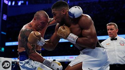 Boxing-Usyk outclasses Joshua to claim world heavyweight titles