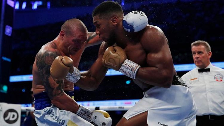 Boxing-Usyk outclasses Joshua to claim world heavyweight titles