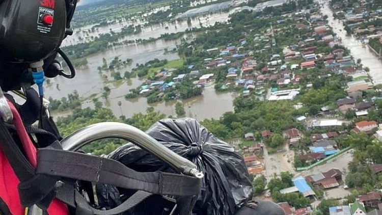 Thai volunteer takes to skies to drop supplies to flood victims