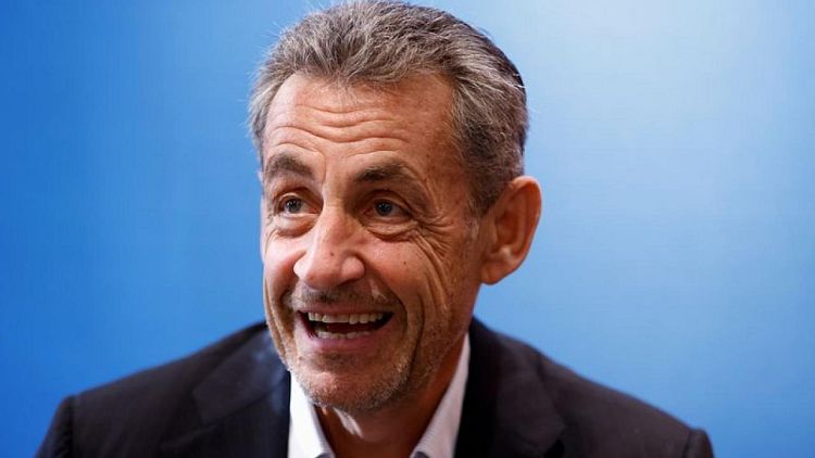 France's Sarkozy plays down new conviction at book signing event
