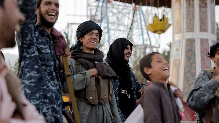 Battle-hardened Taliban fighters enjoy a day off at amusement park