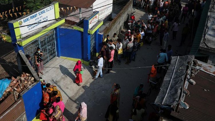 Midnight vigils, snaking queues as some Indians await COVID vaccines