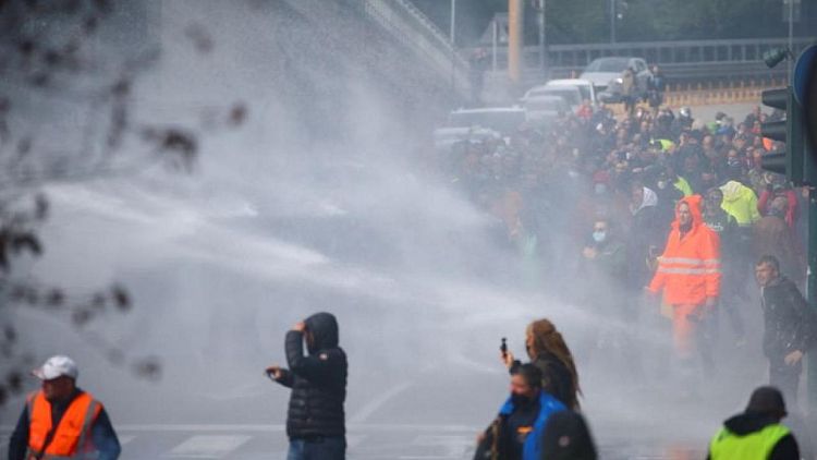 Italian police use water cannon to break up health pass protest at port