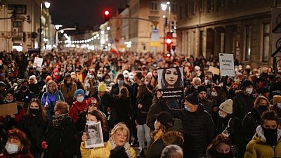 'Her heart was beating too' - Poles protest against strict abortion law