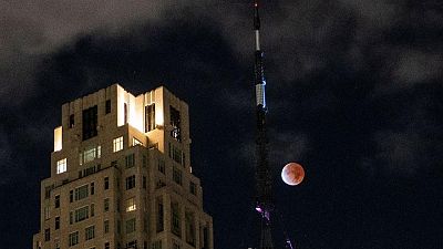 Partial lunar eclipse dubbed 'Blood Moon' dazzles night skies