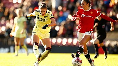 Soccer-Arsenal beat Man United 2-0 to stay top of WSL