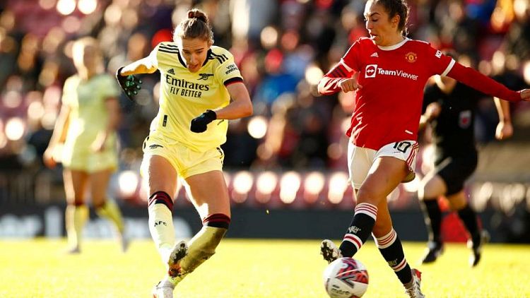 Soccer-Arsenal beat Man United 2-0 to stay top of WSL