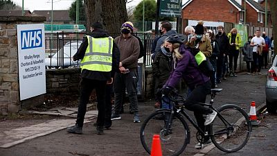 Hundreds queue for vaccines in Britain after Omicron 'tidal wave' warning Hundreds queue for vaccines in Britain after Omicron 'tidal wave' warning