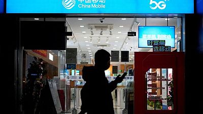China Mobile shares edge higher in Shanghai debut